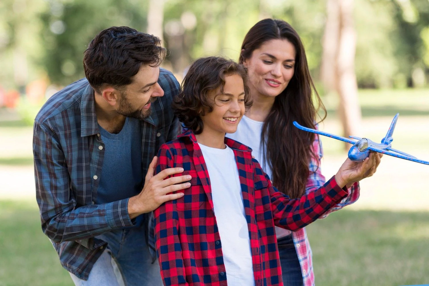 Happy family making roof with hands